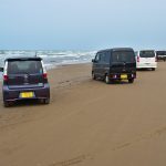千里浜なぎさドライブウェイを走る車と広がる日本海
