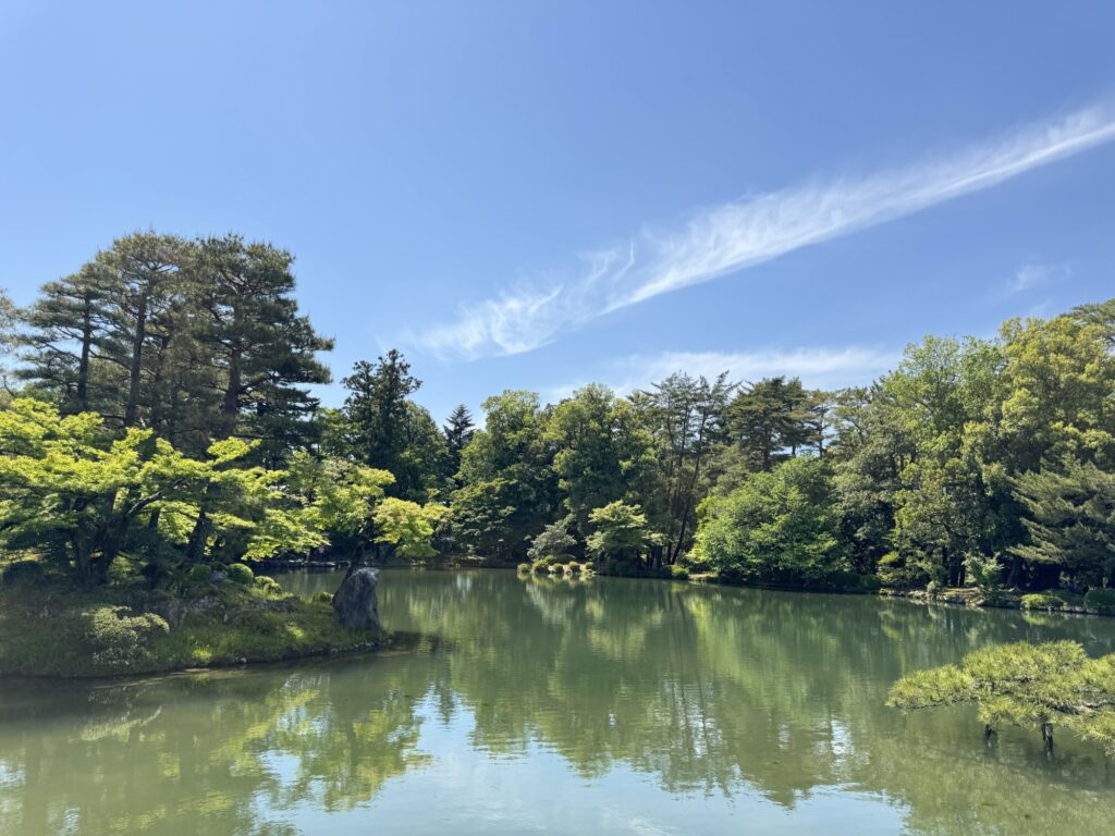 霞ヶ池の水面に映る木々と蓬莱島（兼六園）